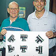 Dutch (left) and Don LaJeunesse hold a skin-packed pad of stainless-steel components in front of their company's new skin packag
