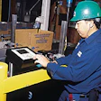 A Blue Diamond technician makes a keypad adjustment to a new case coder (above). Each coder codes up to three lines of type on a