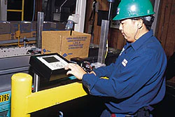 A Blue Diamond technician makes a keypad adjustment to a new case coder (above). Each coder codes up to three lines of type on a
