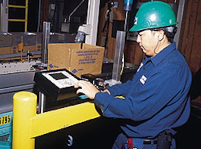 A Blue Diamond technician makes a keypad adjustment to a new case coder (above). Each coder codes up to three lines of type on a