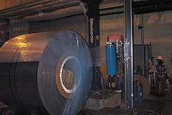 While rotating on powered rollers, a 36,000-lb steel coil is stretch wrapped in 2-mil LLDPE film treated with vapor corrosion in