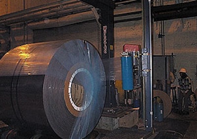 While rotating on powered rollers, a 36,000-lb steel coil is stretch wrapped in 2-mil LLDPE film treated with vapor corrosion in