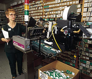 Au-ve-co's Rita Keller (above) tends to a print-and-apply labeler that prints bar codes and information onto labels used for car