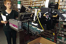 Au-ve-co's Rita Keller (above) tends to a print-and-apply labeler that prints bar codes and information onto labels used for car