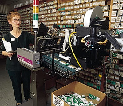 Au-ve-co's Rita Keller (above) tends to a print-and-apply labeler that prints bar codes and information onto labels used for car
