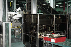 Sanford's bulk loading system also with cartoner and case packer features a conveyor bridge that permits one operator to attend