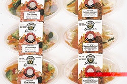 A hole in the paperboard sleeve exposes the one-way valve so that internal gas pressure created by the respiring vegetables can