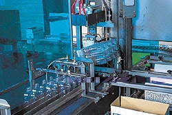 12 bottles are gripped mechanically by their necks and rotated 180?