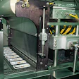 Robotic pick-and-place tool (top) loads eight trays at a time into carrier plates that deliver the trays to the evacuation/backf