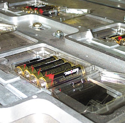 Integrated section comprises 8-up clamshell denesting onto a custom conveyor that moves left to right (above). Midway of the mac