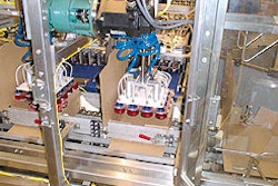 Coupling that connects the servo motor to the pick-and-place carriage can be seen onboard the case packer at the very top of the
