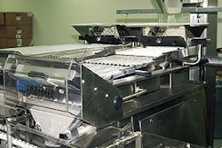 Overhead hoppers on each electronic tablet counter are fed by a bucket that travels on demand from a floor-level hopper (inset)
