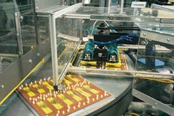 A customized pick-and-place arm places markers into blister cavities on the rotary table of an eight-station heat-sealing machin