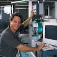 Hank Whetstone pauses at the PC keyboard through which he controls his high-speed candy-wrapping machine.
