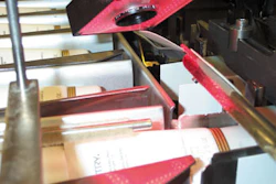 The vision sensor's hand controller for set-up parameters is wired through the cartoner's main panel (above) with the view displ