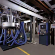 The output from three extruders combines, then rises to form the bubble at the upper left side of the photo. The panel on the ri