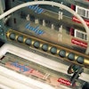 The labeler uses two parallel conveyors (below). In this photo, an open, toothbrush-filled case enters the machine from the conv