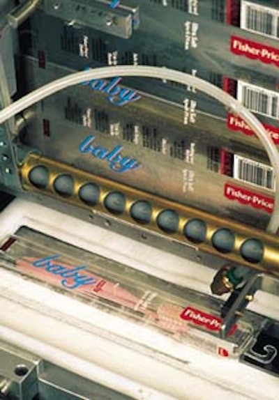 The labeler uses two parallel conveyors (below). In this photo, an open, toothbrush-filled case enters the machine from the conv