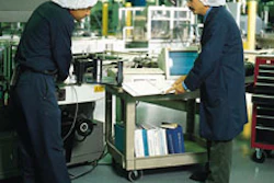 Photo (above) shows Nick Marinaro (at right) running through a training session on a labeler with mechanic Ramon Pichardo. Photo