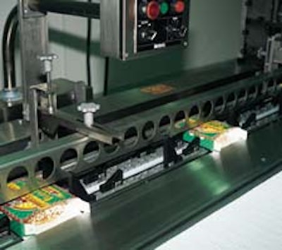At Southland Bagel, preglued sleeves are erected and placed in a flighted conveyor (left) so operators can slide pizza bagels in
