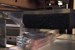 Six cased toothbrushes are bundled in a curtain of film formed from two separate webs.
