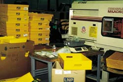 At Pitney Bowes' Danbury, CT, plant, plastic corrugated totes are kept by workstations (above) where workers use them to pack in