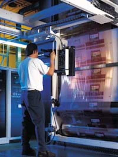 A Friedman Bag employee checks a Green Giant press run for color quality (left). A filled bag (top right) shows off the product'