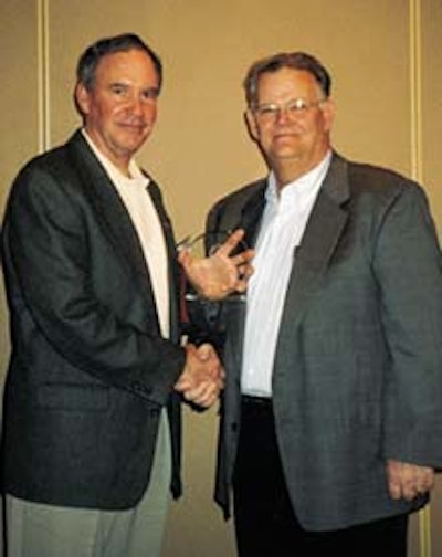 Bob Wyatt (left) of DuPont Cyrel accepts the 2000 Technological Innovator of the Year award from Randy Stober, FPPA Awards Judgi