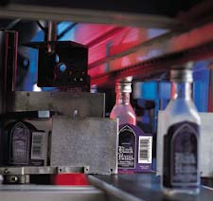 Top photo shows the labeling station that applies labels to the square PET bottles. A spring-mounted overhead conveyor (above) h
