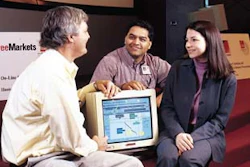 Watching the bid unfold: John Gellatly (left) and Satish Bhagwat of Owens Corning join Kara Csensich of FreeMarkets on bid day.