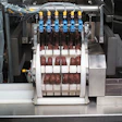 Sara Lee's mini-donut packing system uses an unusual continuous-motion rotary drum loader (seen at left and up close at far left