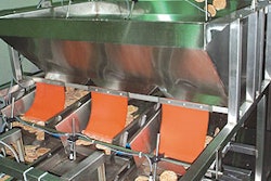 Sausage patties exit the freezer on a conveyor and flow into a pivot pan that feeds patties into a bulk-and-dribble scale (right