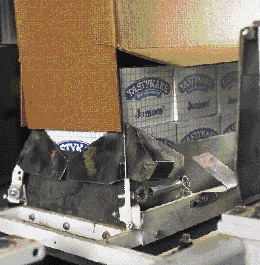 As cartons are lifted up into the corrugated case, a loading tube keeps carton edges from catching on the edges of the case, t
