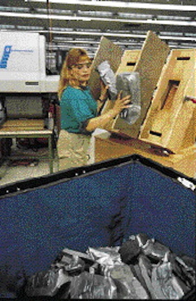 The hardened corner cushions are taken from the molds and placed in plastic bins to be used as needed by the packagers