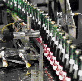 A sensor placed directly across from the coder (left) communicates to the coder when a bottle passes in front of it. The ink-je