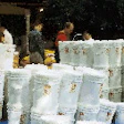 Survivalists unload a shipment of 6-gal buckets containing dehydrated food packaged with oxygen absorbers.