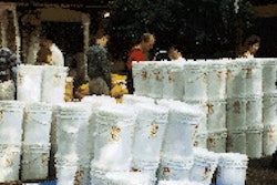 Survivalists unload a shipment of 6-gal buckets containing dehydrated food packaged with oxygen absorbers.