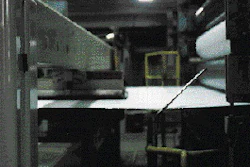 A scanning device traverses a web of linerboard to measure the material?s basis weight and moisture content at the Morrilton mil