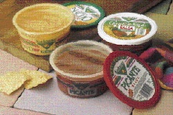 Peelable lidstock is heat-sealed to hot-filled cups of salsa (left) on an intermittent-motion cup filling machine. Before sealin