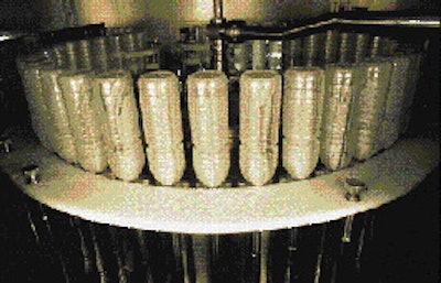 Inside the first sterile chamber of the rotary aseptic system, bottles are sterilized with a spray of oxonia