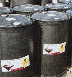 These plastic drums, ready for filling, are labeled with appropriate warnings for hazardous materials