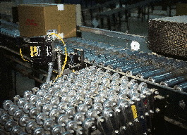 As a case moves down a powered roller conveyor, its bar code is scanned. This information is sent directly across an industri