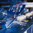 The output from all ten robots is handled by a single flow wrapper that wraps trays at 90/min (right). Operators can monitor the
