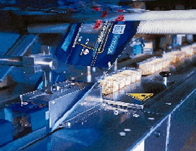 The output from all ten robots is handled by a single flow wrapper that wraps trays at 90/min (right). Operators can monitor the
