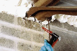 Users spray foam from the returnable containers onto everything from buildings (shown) to refrigerated trucks.