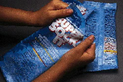 Flexible packs of chlorine shock treatment products for swimming pools maintain child-resistance while offering users an easy-op