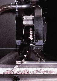 Once wrapped and sealed, individual pieces of Creme Savers are discharged onto a takeaway conveyor