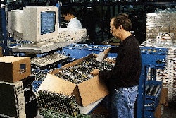 A 3Com employee scans a serial number on an adapter card. That information is entered into the computer at this workstation