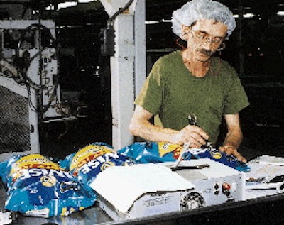 Roland Baker (inset) checks the nitrogen level in bags of Wise potato chips. To package its chips, Wise Foods, uses 33 bagging m