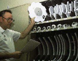 Parts room manager Jim Ryder uses a parts pick list to gather a starwheel for a rotary labeler for a Line 24 changeover